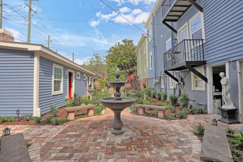 a fountain in the middle of a brick courtyard with benches at New2/2 Garden Apartment Historic in Savannah
