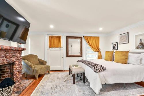 a bedroom with a large bed and a fireplace at New2/2 Garden Apartment Historic in Savannah