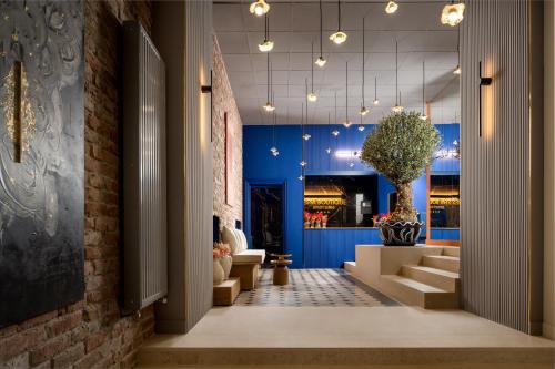 a lobby with a plant in a vase in a building at Siesta Boutique Smart Suites in Cluj-Napoca