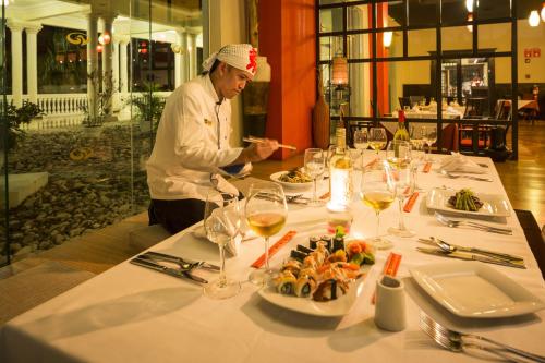 a chef preparing food at a table in a restaurant at Grand Palladium Jamaica Resort & Spa All Inclusive in Lucea