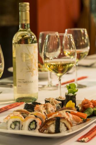 a plate of sushi and wine glasses on a table at Grand Palladium Jamaica Resort & Spa All Inclusive in Lucea