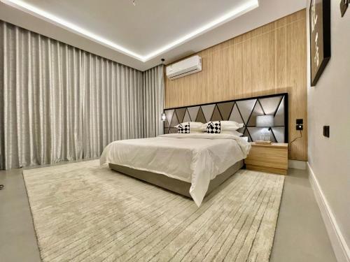 a bedroom with a large bed in a room at C Living - Executive - AQIQ in Riyadh