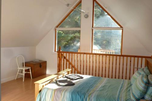 a bedroom with a bed and a large window at The Bothy, Nethy Bridge in Nethy Bridge