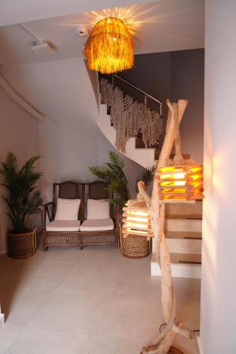 a room with a staircase with chairs and a chandelier at LARA BOUTIQUE HOTEL Antalya in Lara