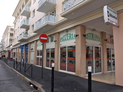 a store front of a building with a red street sign at a lovely nest in Bussy-Saint-Georges