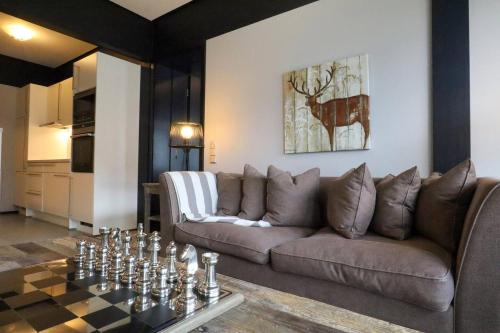 a living room with a couch and a table at Lauchernalp Resort Residences in Wiler