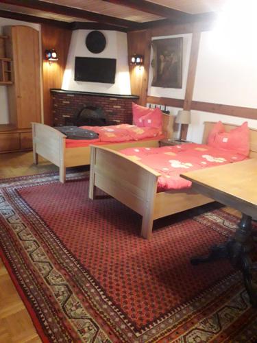 - une chambre avec 2 lits, une table et une cheminée dans l'établissement Wacholderweg 10,Hans Hyzak, à Düsseldorf
