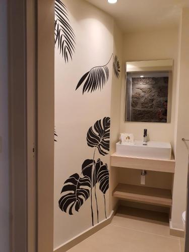 a bathroom with a sink and a mirror at Botica House in Póvoa de Lanhoso