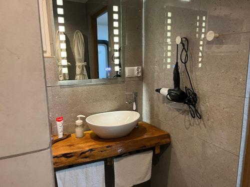 a bathroom with a bowl sink and a mirror at Wąkop 6 Agroturystyka Eco in Nowa Słupia