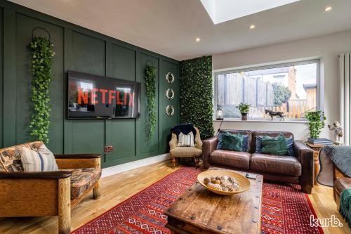 a living room with a couch and a tv at Carlton Hill House - 5 Bedroom House with Parking in Nottingham