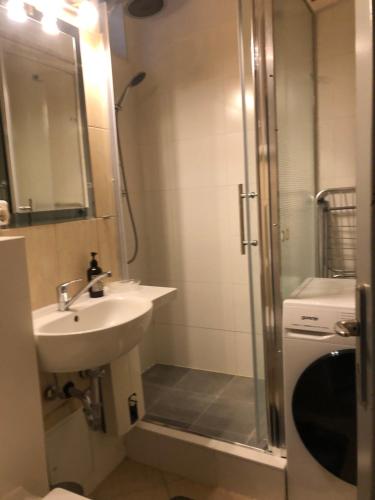 a bathroom with a sink and a shower at Sky view Neukölln in Berlin