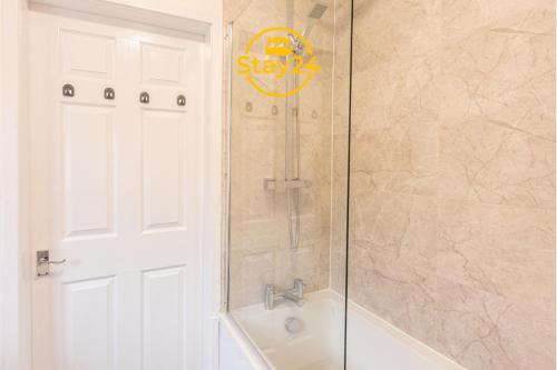 a bathroom with a shower with a tub and a sink at Elizabeth Place in Crewe