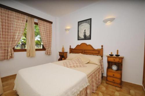 a bedroom with two beds and a window at Cora in Port d'Alcudia