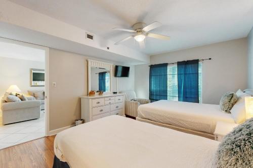 a bedroom with two beds and a ceiling fan at Sea Oats 208 in Fort Walton Beach