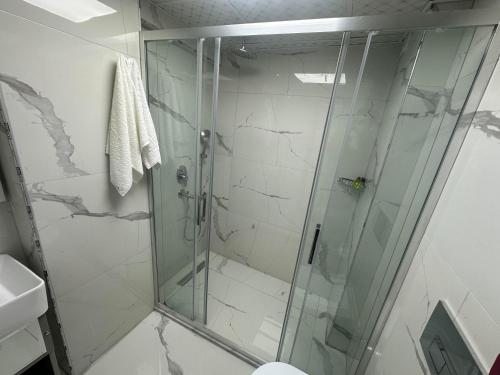 a shower in a bathroom with a glass shower stall at gazelle suites in Istanbul