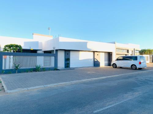 a white van parked in front of a building at Essence Lifestyle Self-Catering Accommodation - Academia in Windhoek