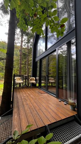 a house with a wooden deck with windows at Chata Patúch in Babkov