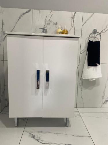 a white cabinet with a sink in a bathroom at Rollers Rest Guesthouse in Boksburg