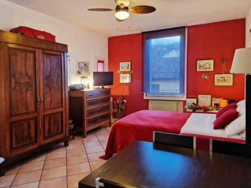 ボローニャにあるCa di Valeの赤い壁のベッドルーム1室(ベッド1台、窓付)