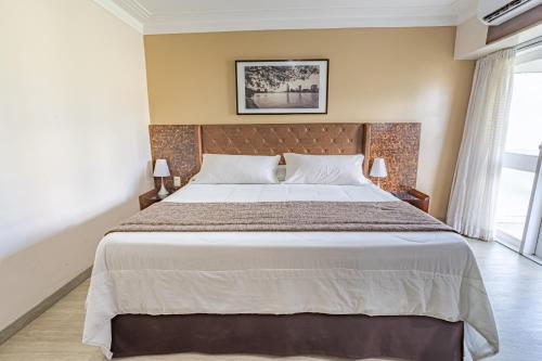 a bedroom with a large bed in a room at Hotel Village Premium Campina Grande in Campina Grande