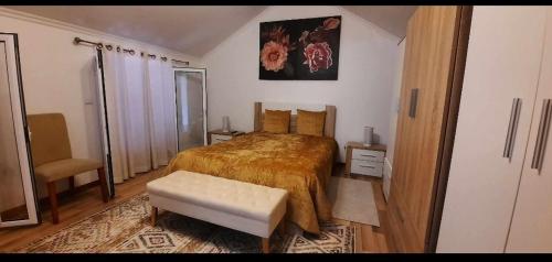 a bedroom with a bed and a stool in it at Casa da Avó in Machico