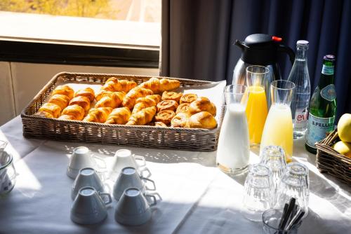 a table with a basket of donuts on a table at Campanile Limoges Centre - Gare in Limoges
