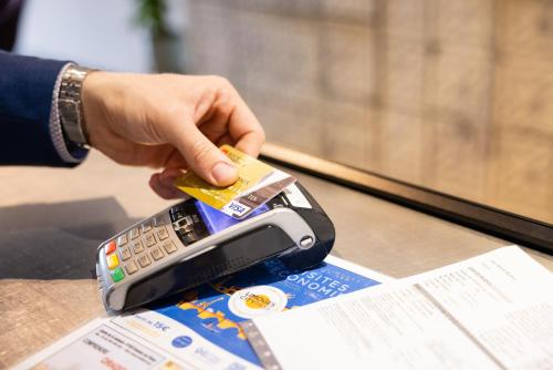 a person is inserting a credit card into a cell phone at Campanile Limoges Centre - Gare in Limoges