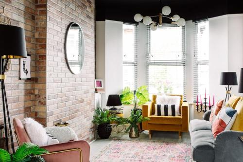 a living room with two couches and a brick wall at Designer 4-Bed Home in the Heart of Belfast in Belfast