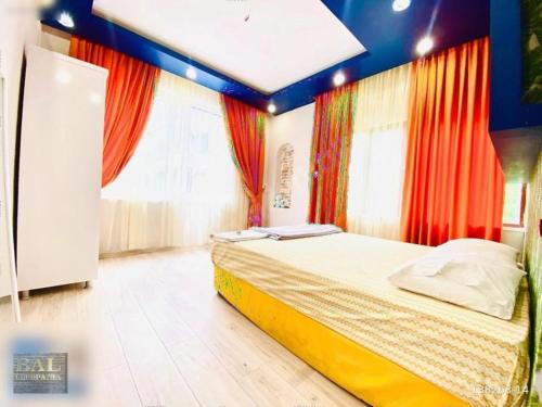 a bedroom with a bed in a room with curtains at Deniz Pansiyon in Alanya