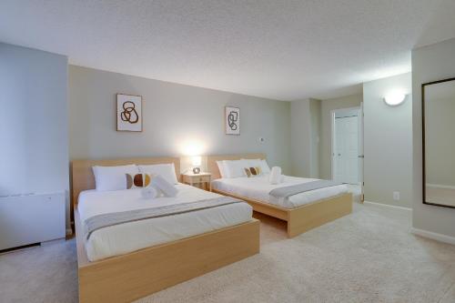 a bedroom with two beds and a flat screen tv at Convenient Condo Near Crystal City Metro Station in Arlington