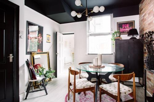 a dining room with a glass table and chairs at Designer 4-Bed Home in the Heart of Belfast in Belfast