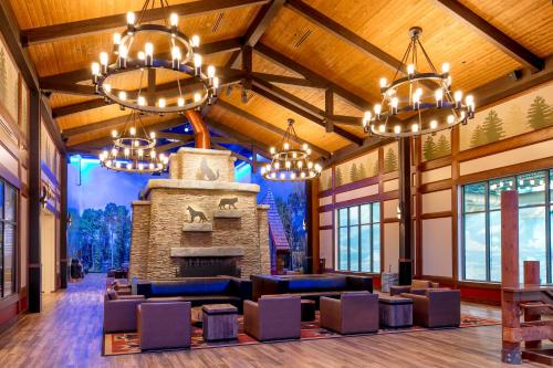 a lodge lobby with chandeliers and a fireplace at Great Wolf Lodge Chicago/Gurnee in Gurnee