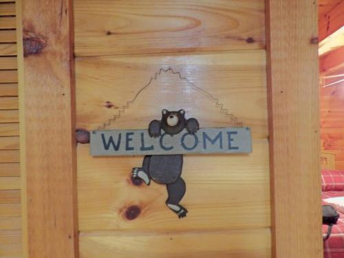 a welcome sign on a door with a koala on it at Yogi's Den: Breathtaking Views! 3 min to Dollywood, on 1 acre! in Sevierville