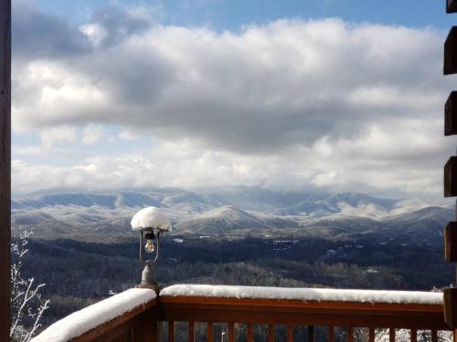 a snow covered balcony with a view of mountains at Yogi's Den: Breathtaking Views! 3 min to Dollywood, on 1 acre! in Sevierville