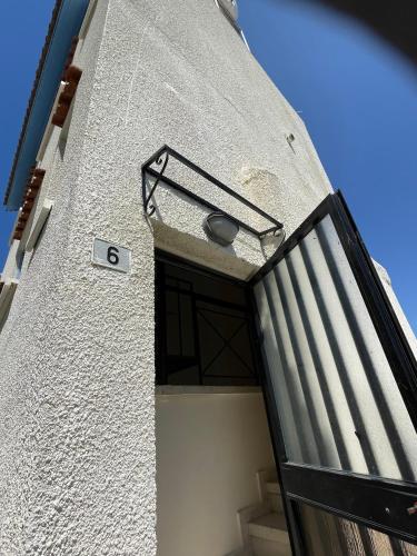 a building with a door with the number six at Pissouri Village Studios in Pissouri