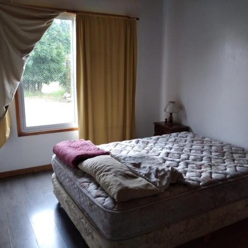 a bed sitting in a bedroom with a window at mis perros in Mar del Plata