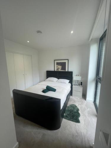 a bedroom with a large bed with a black headboard at 2 BED 4 ADULTS IN ROYAL WHARF in London