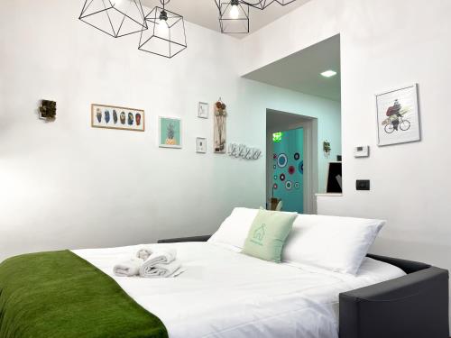 a bedroom with a white bed with a green blanket at [150m to Metro A] 3 Bedrooms & 2 Bathrooms - Family friendly in Rome