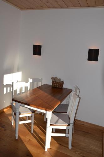 a dining room table with a white table and chairs at Bergbauernhof Obergaisberg in Kirchberg in Tirol