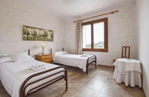 カンパネにあるPla de Ses Rotesのベッド2台と窓が備わるホテルルームです。