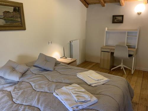 a bedroom with a bed with two towels on it at The Mayor's in Trecastagni