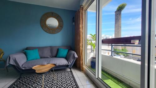 a living room with a couch and a window at Studio Océan City in Saint-Pierre