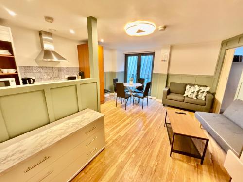 a living room with a couch and a table at Two bedrooms flat - Manchester city centre in Manchester