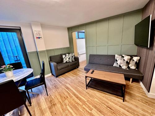 a living room with a couch and a table at Two bedrooms flat - Manchester city centre in Manchester