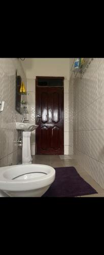 a bathroom with a toilet and a sink at Muhabura view imfizi farmhouse in Kisoro