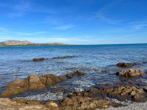 a view of the ocean with rocks in the water at Stazzo Casa Bianco Fly in Aggius