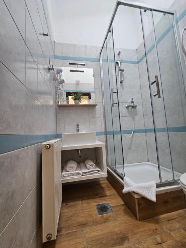 a bathroom with a sink and a shower at Drava Osijek in Osijek