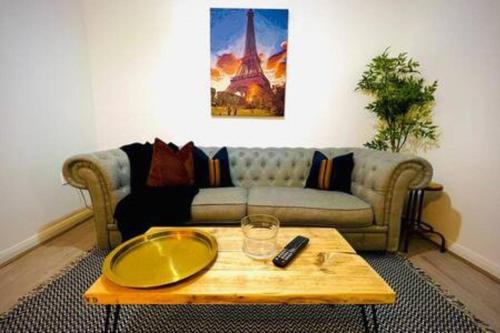 a living room with a couch and a coffee table at Cosy - Stylish - Close to Centre in Cardiff