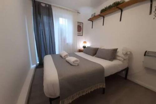a bedroom with a bed with towels on it at Cosy - Stylish - Close to Centre in Cardiff