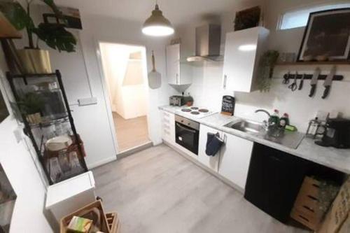 a small kitchen with a sink and a stove at Cosy - Stylish - Close to Centre in Cardiff
